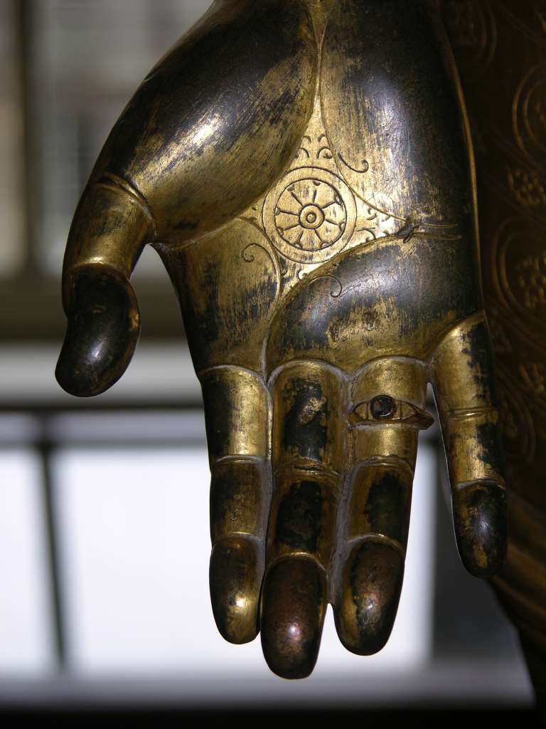 British Museum Top 20 Buddhism 09-3 Standing Avalokiteshvara Hand Close Up Standing Avalokiteshvara  Nepal, 16C AD, 138cm high. Here is a close up of the palm of Avalokiteshvaras right hand, held in the giving (charity) mudra and showing the lotus and chakra (wheel).
